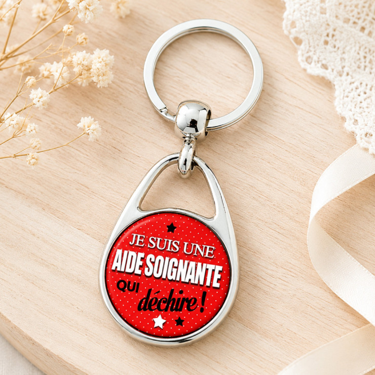                     Porte clé "Je suis une aide soignante qui déchire !"
                  